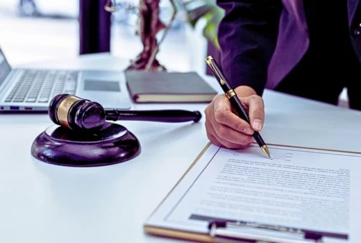 A male lawyer is signing a plea agreement with a client